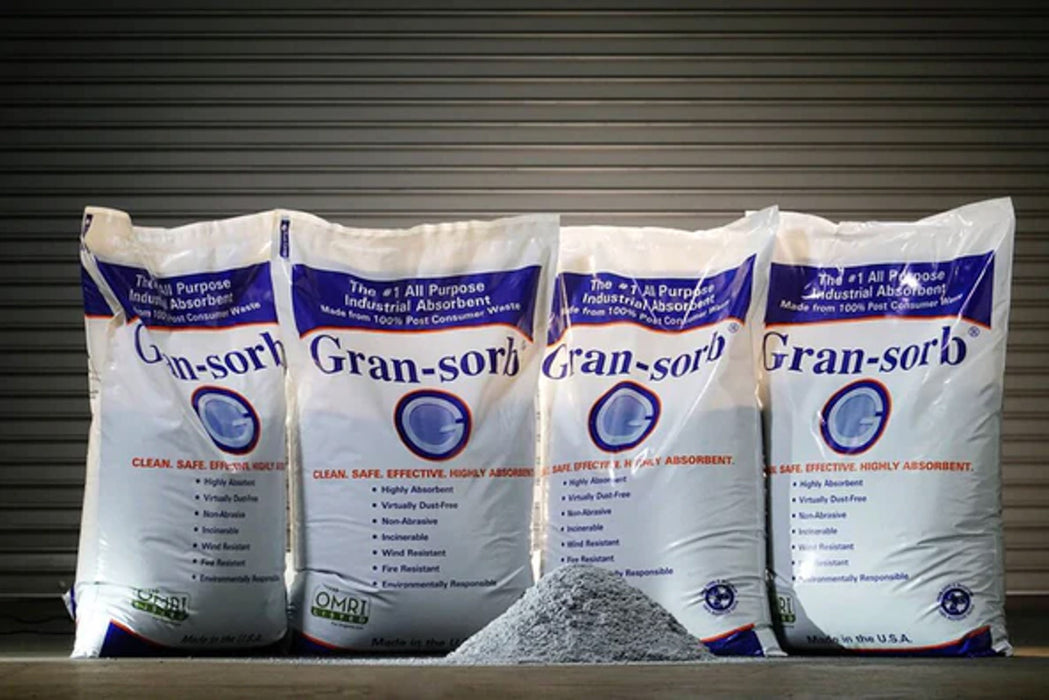 4 bags of Gran-sorb with a pile of the absorbent in front of them
