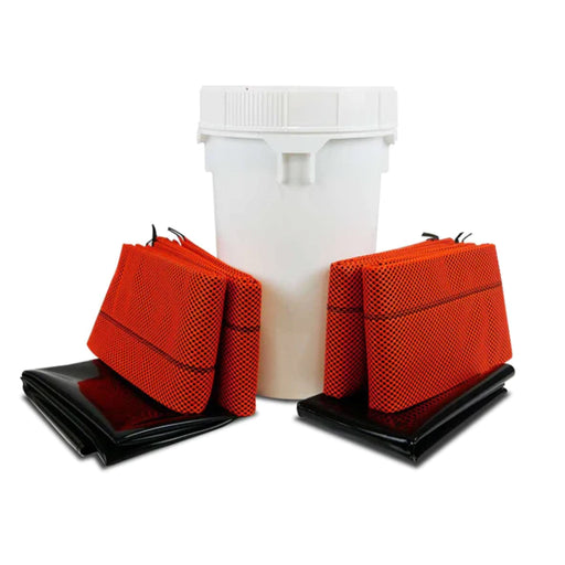 A small white drum with bright orange barriers and black mats