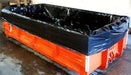 An large orange dumpster with a black liner in it